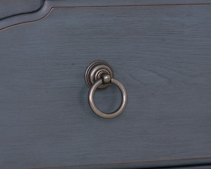 Blue accent chest with round metal ring pull on blue wood surface on Tampa Home & Garden Store