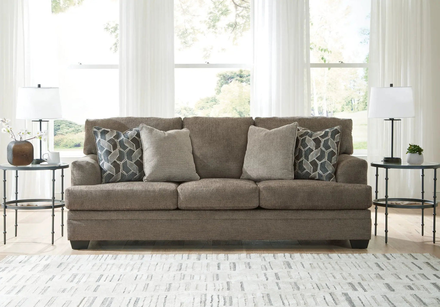 Stonemeade Living Room Set taupe sofa with geometric pillows, flanked by end tables and lamps on Tampa Home & Garden Store