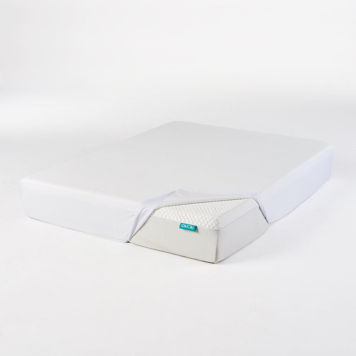 OkiOki King Mattress Protector by HouseOfZazla in light gray fabric with turquoise tag on Tampa Home & Garden Store
