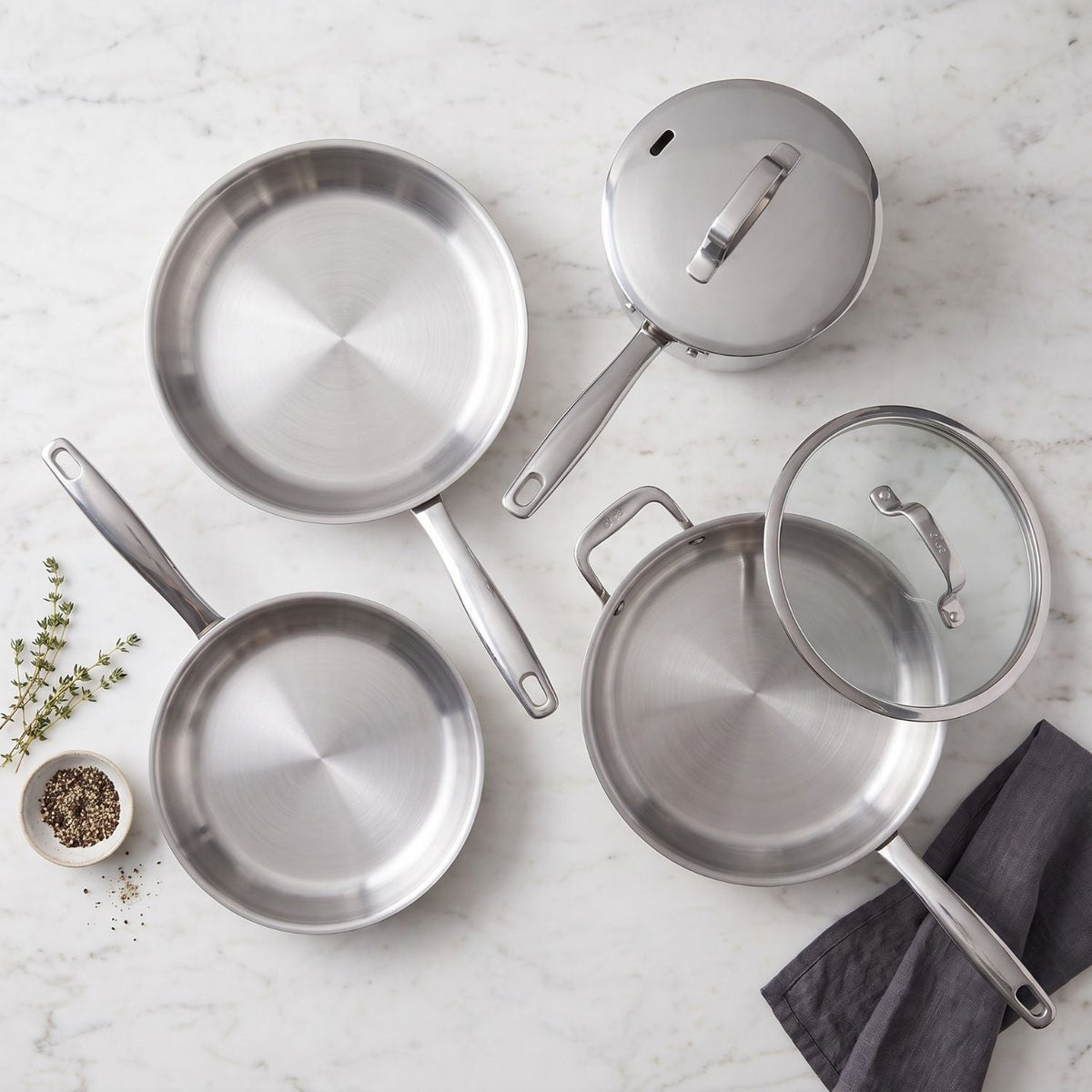 5-Ply Stainless Cookware Set, 7-Piece with stainless pots and glass lid on marble countertop on Tampa Home & Garden Store