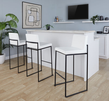 High-back barstool set of three with white cushions and black frames at marble bar setting on Tampa Home & Garden Store