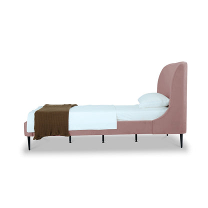 Heather upholstered bed with curved pink headboard, black legs, white bedding, brown throw on Tampa Home & Garden Store