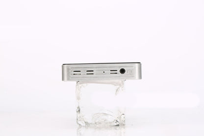 Home wireless projector, silver metal body with vented side panel and circular port on Tampa Home & Garden Store