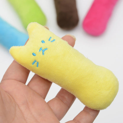 Yellow plush cat-shaped chew toy with blue embroidered face held in hand on Tampa Home & Garden Store