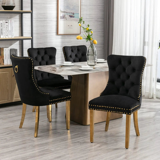 Solid wood velvet dining chairs black with tufted backs, gold nailhead trim around marble table on Tampa Home & Garden Store