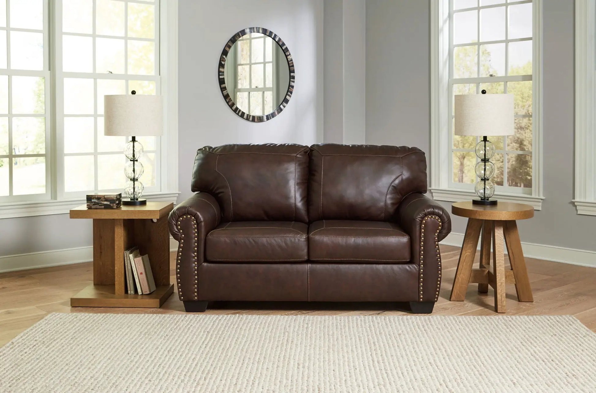 Colleton brown leather stationary sofa with nailhead trim, flanked by glass lamps on Tampa Home & Garden Store