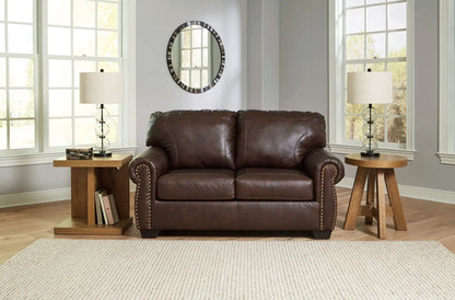 Colleton brown leather stationary sofa with nailhead trim, flanked by glass lamps on Tampa Home & Garden Store