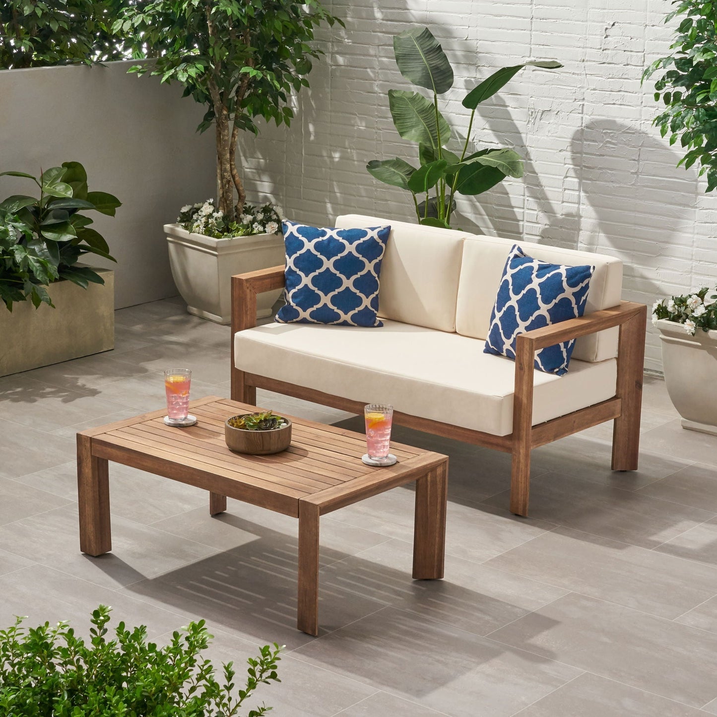2-Piece Patio Set with open-back loveseat and coffee table, beige cushions and wood frame on Tampa Home & Garden Store