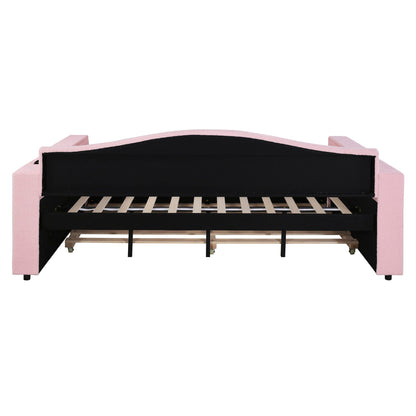 Upholstered pink daybed frame with black back panel, exposed wooden slats and caster wheels on Tampa Home & Garden Store