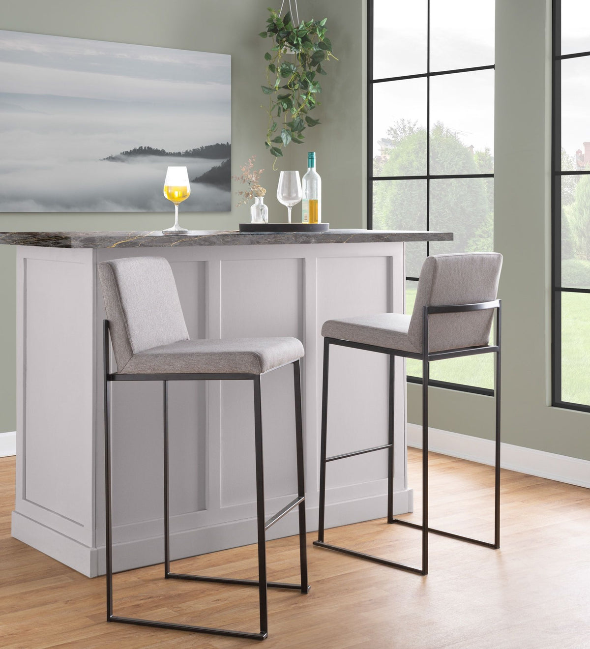 Two high-back barstools in light gray upholstery with black metal frames at marble island on Tampa Home & Garden Store