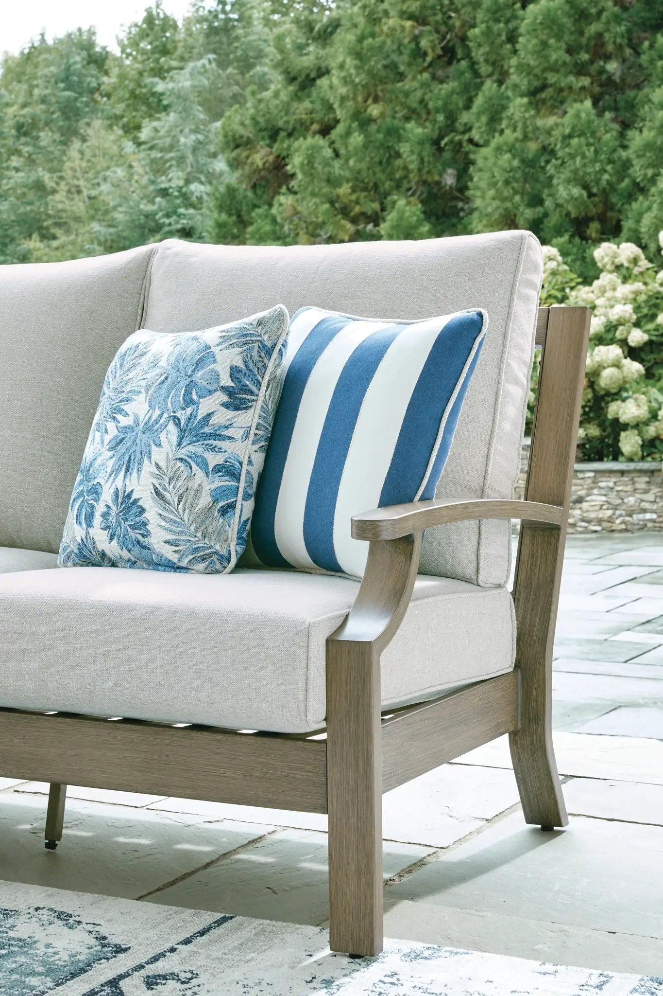 Rainier Ranch sofa with cushion brown wood frame outdoor sofa with blue striped pillows on Tampa Home & Garden Store