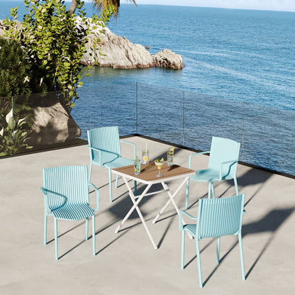 4 turquoise stackable plastic armchairs surround a folding square table with a wooden top on Tampa Home & Garden Store