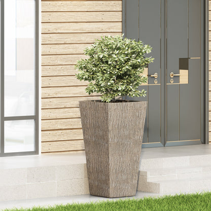 MGO Planter with textured gray concrete pot and green shrub against wood siding and gray doors on Tampa Home & Garden Store