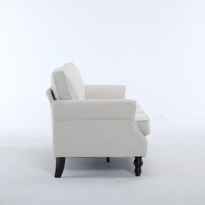 Beige rolled-arm fabric chair with nailhead trim and dark wooden legs on Tampa Home & Garden Store
