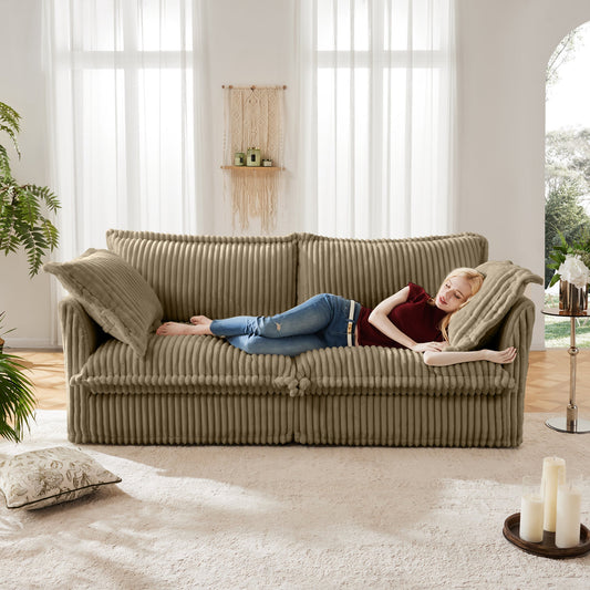 Modern Slipcovered 2-Seat Sofa by HouseOfZazla in taupe corduroy with a person resting on Tampa Home & Garden Store