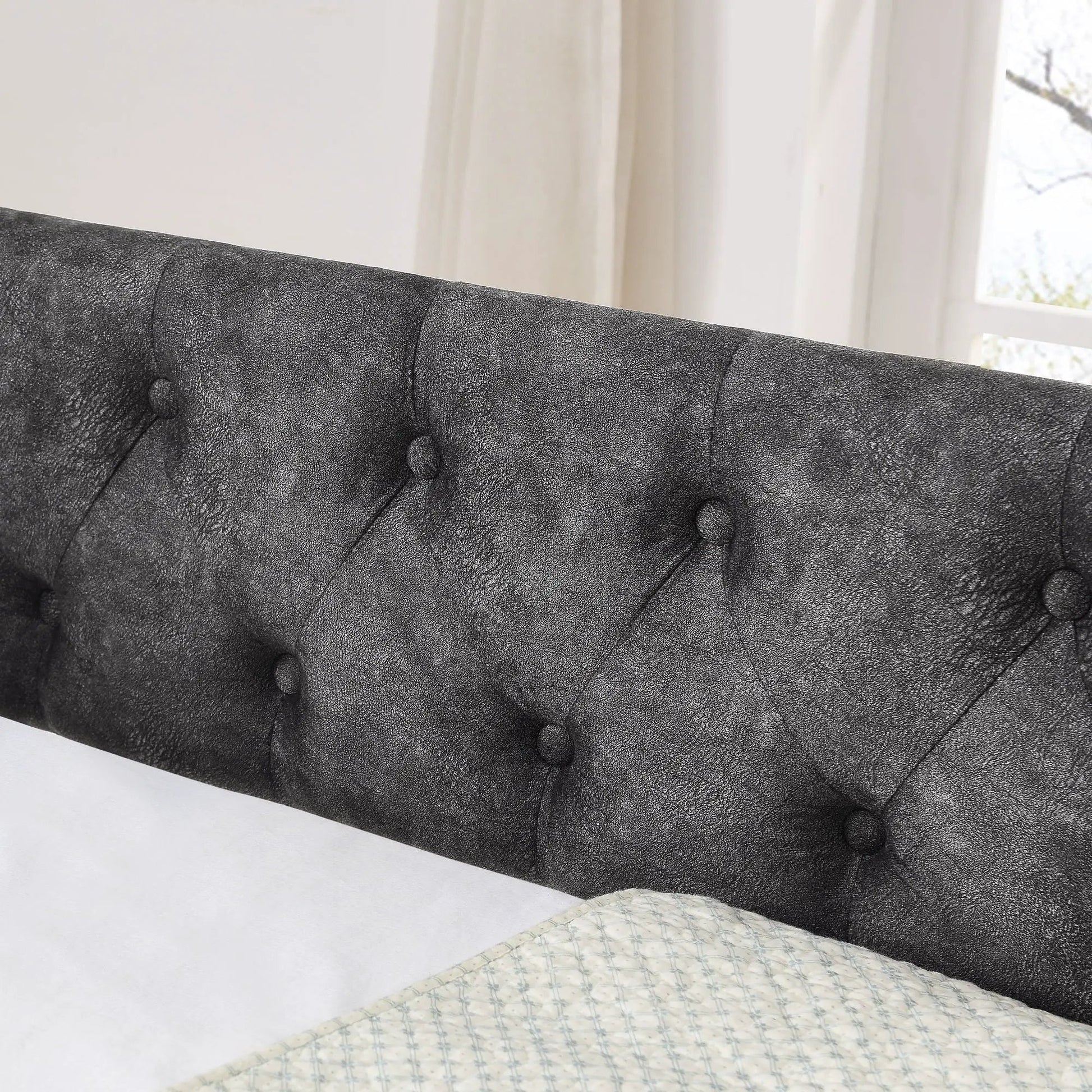Upholstered daybed in dark grey textured fabric with tufted detailing on Tampa Home & Garden Store