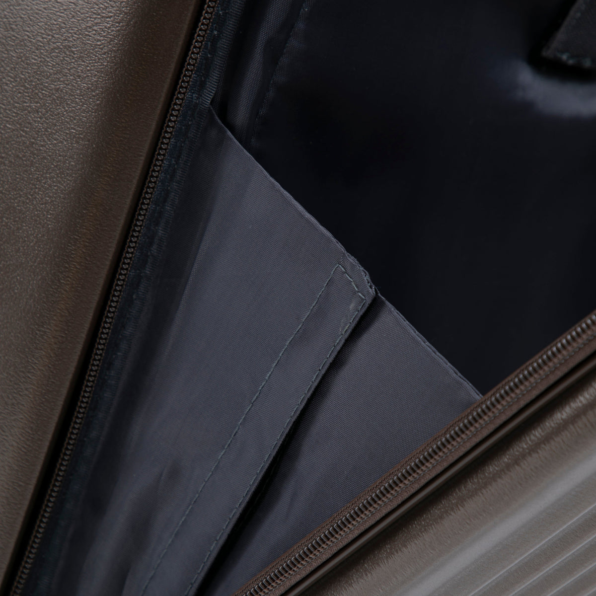 Luggage set interior close-up with brown faux-leather exterior and dark fabric lining on Tampa Home & Garden Store