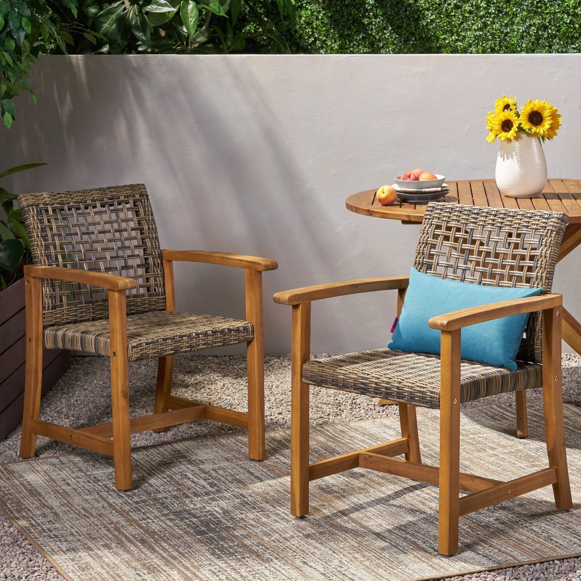 Outdoor dining chairs set of 2 with acacia wood frames, woven wicker seats, turquoise cushions on Tampa Home & Garden Store