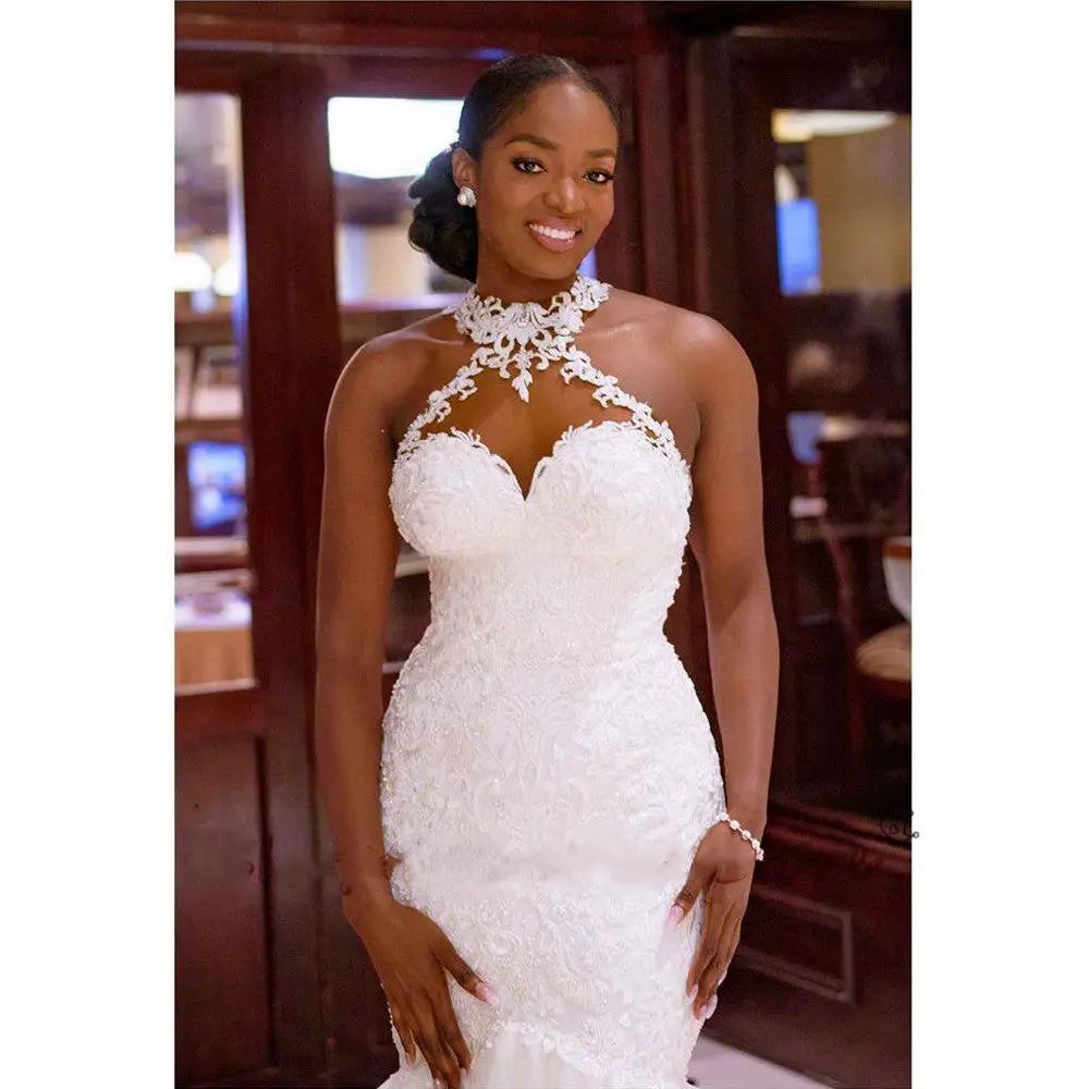 Mermaid wedding dress in white with vintage lace and beaded bodice, sheer halter neck on Tampa Home & Garden Store