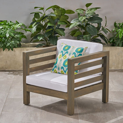 Outdoor acacia wood arm chair with white cushion and turquoise pillow by HouseOfZazla on Tampa Home & Garden Store