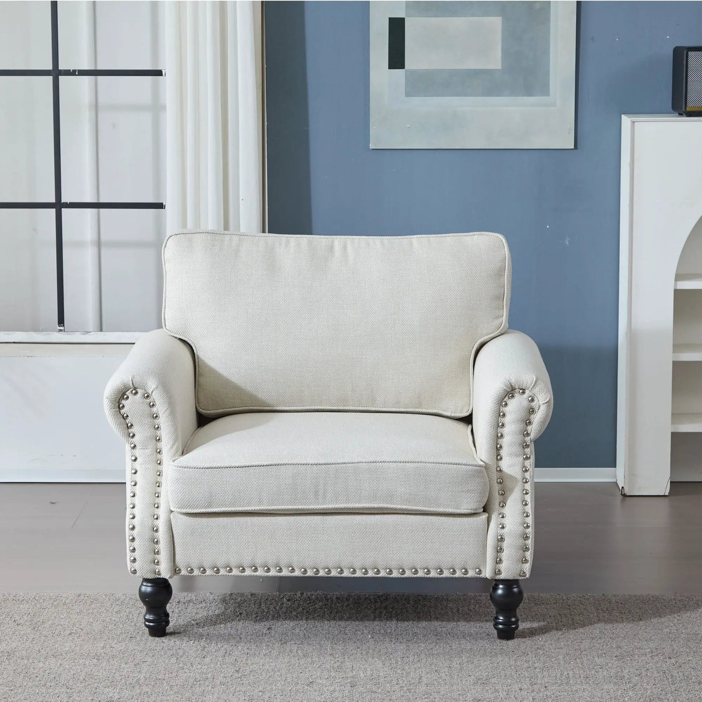 Rolled-arm sofa in beige fabric with nailhead trim and dark wood legs on Tampa Home & Garden Store