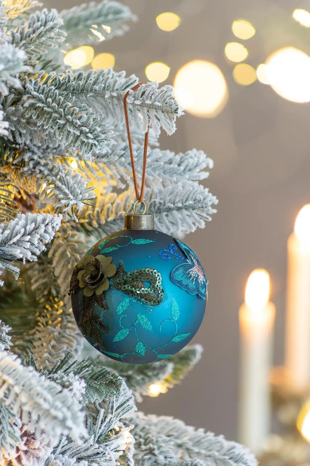 Glass turquoise Christmas ball ornament with teal floral metallic accents on Tampa Home & Garden Store