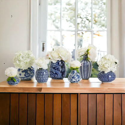 Samira blue porcelain vases set of seven with white hydrangea blooms on a wooden table on Tampa Home & Garden Store