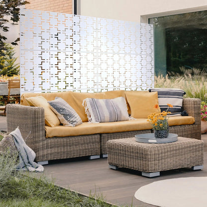 Two-panel outdoor metal privacy screen with geometric cutouts in white on wicker seating area on Tampa Home & Garden Store