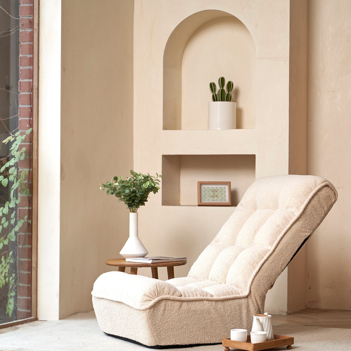 Reclining chair with beige plush upholstery sits in a cozy balcony nook with plants on Tampa Home & Garden Store