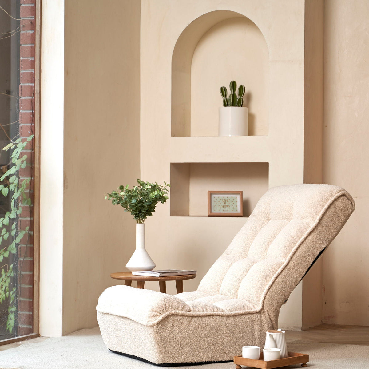 Reclining chair with beige plush upholstery sits in a cozy balcony nook with plants on Tampa Home & Garden Store
