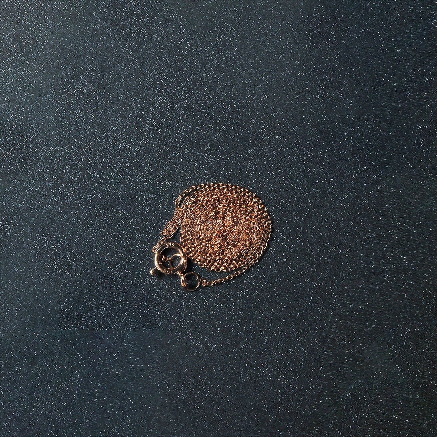 14k rose gold diamond-cut cable link necklace 0.7mm, thin coiled on dark background on Tampa Home & Garden Store