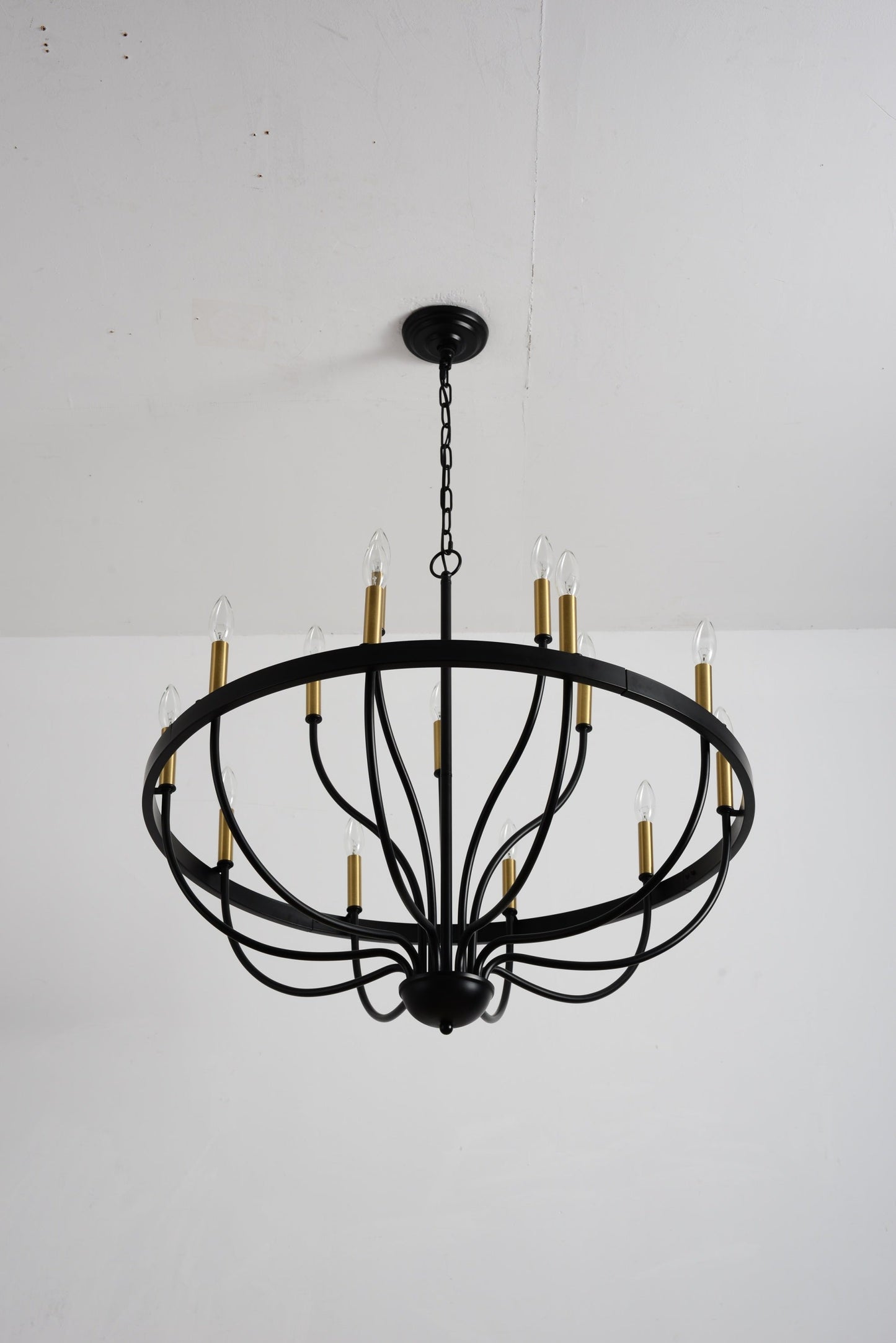 18-light industrial black iron chandelier with frame and brass candle cups hanging by chain on Tampa Home & Garden Store