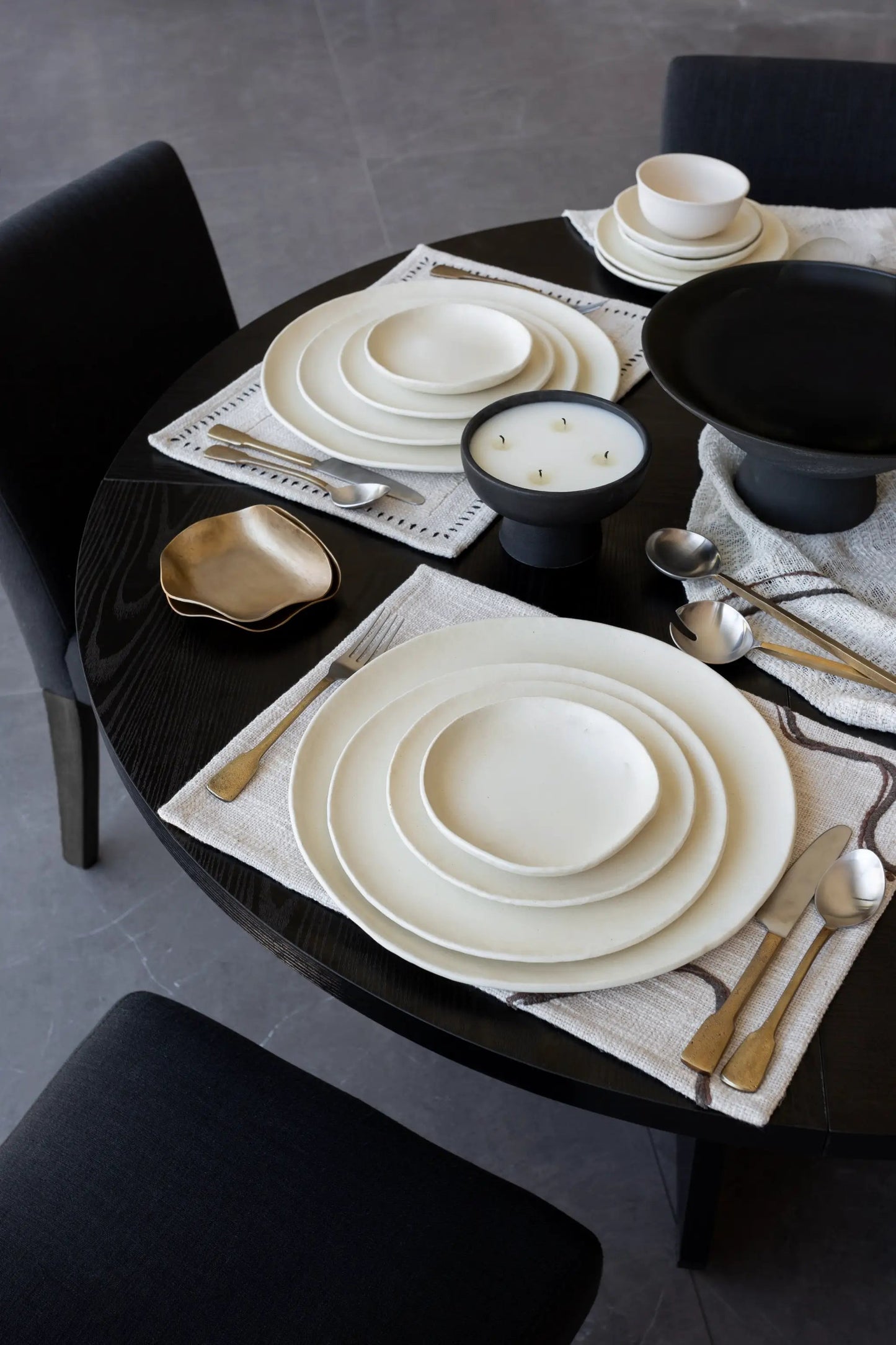 Kodo 4 Piece Place Setting plates by dumæ in cream ceramic, with a bowl and gold flatware on Tampa Home & Garden Store