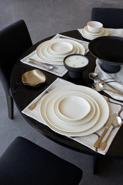 Kodo 4 Piece Place Setting plates by dumæ in cream ceramic, with a bowl and gold flatware on Tampa Home & Garden Store