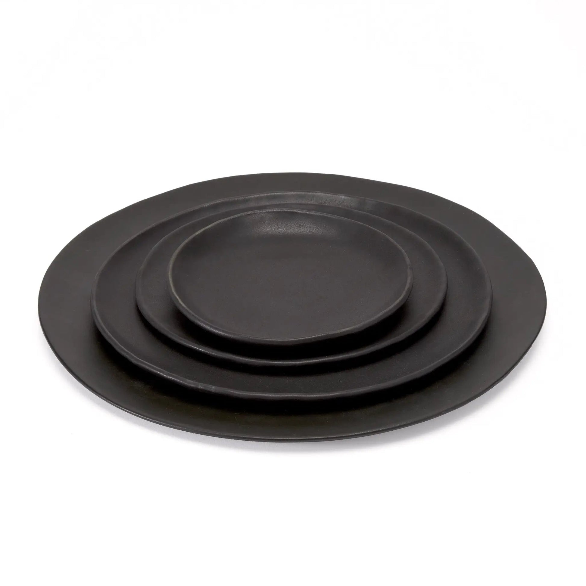 Kodo 4 Piece Place Setting plates by dumæ, black matte dinnerware set of four, stacked on Tampa Home & Garden Store