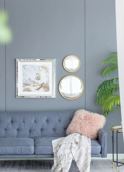 Round mirrors with gold iron frames, set of two on gray wall beside silver-framed artwork on Tampa Home & Garden Store