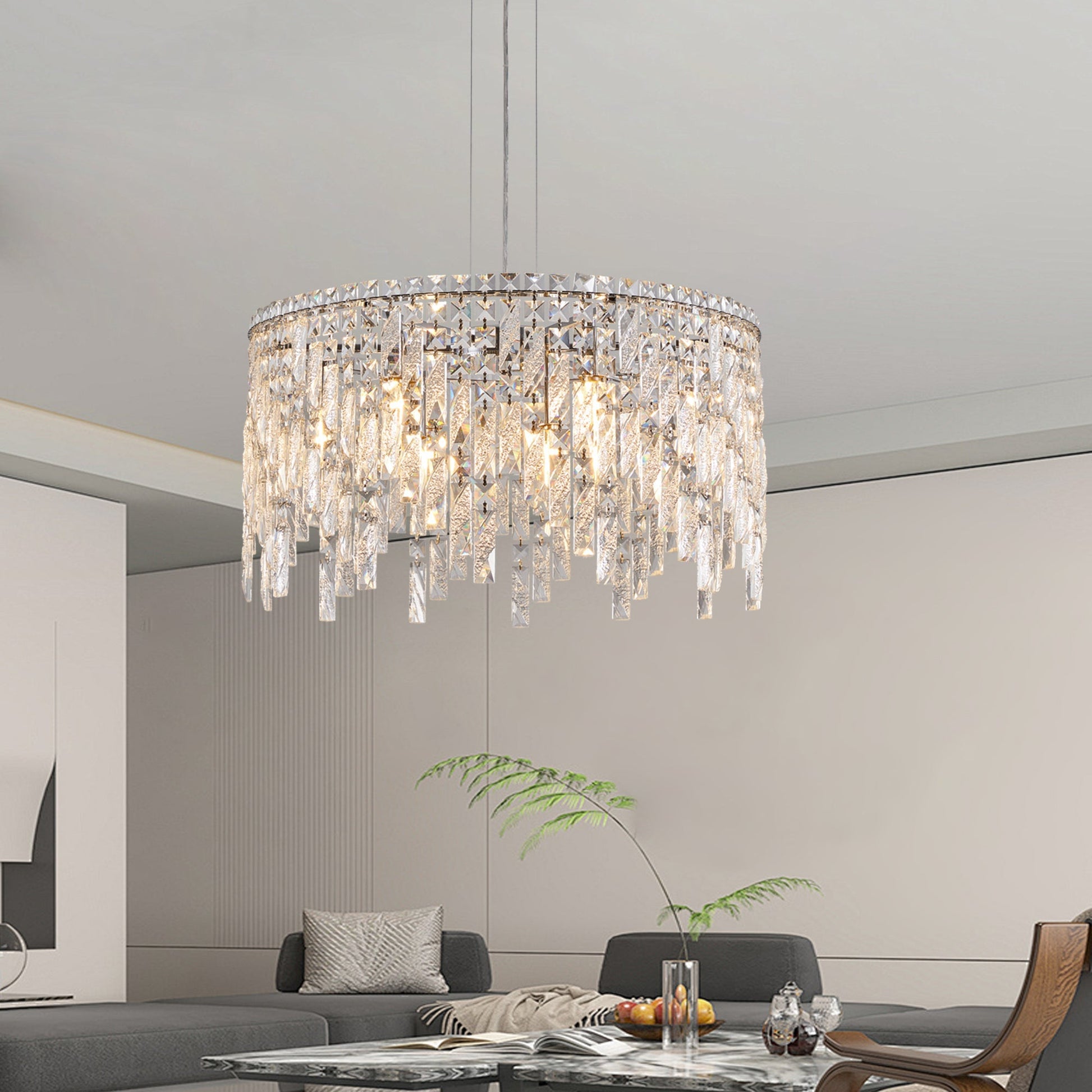 24-inch round silver crystal chandelier with cascading prisms in a modern living room over a glass coffee table on Tampa Home & Garden Store