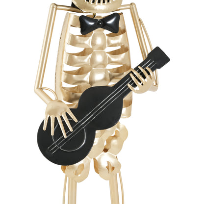 Gold-tone metal skeleton musician statue playing a black guitar with bow tie on Tampa Home & Garden Store