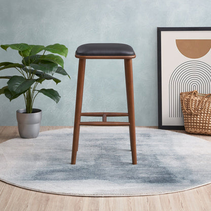 Bar height stool 28-30in with black upholstered seat and warm wood legs on Tampa Home & Garden Store