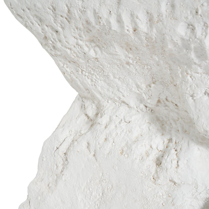 Close-up of a white, rough stone surface with pockmarked texture on Tampa Home & Garden Store