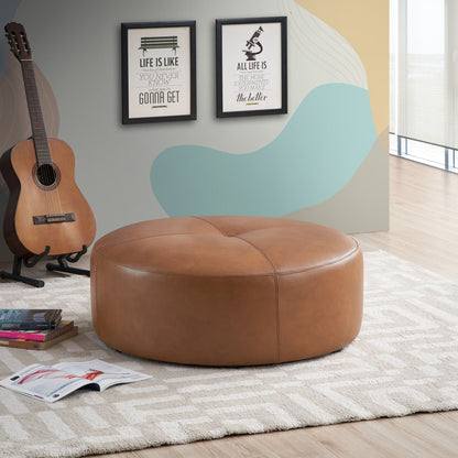 Tan leather mid-century modern upholstered ottoman, 36-inch, in a room with a guitar on Tampa Home & Garden Store