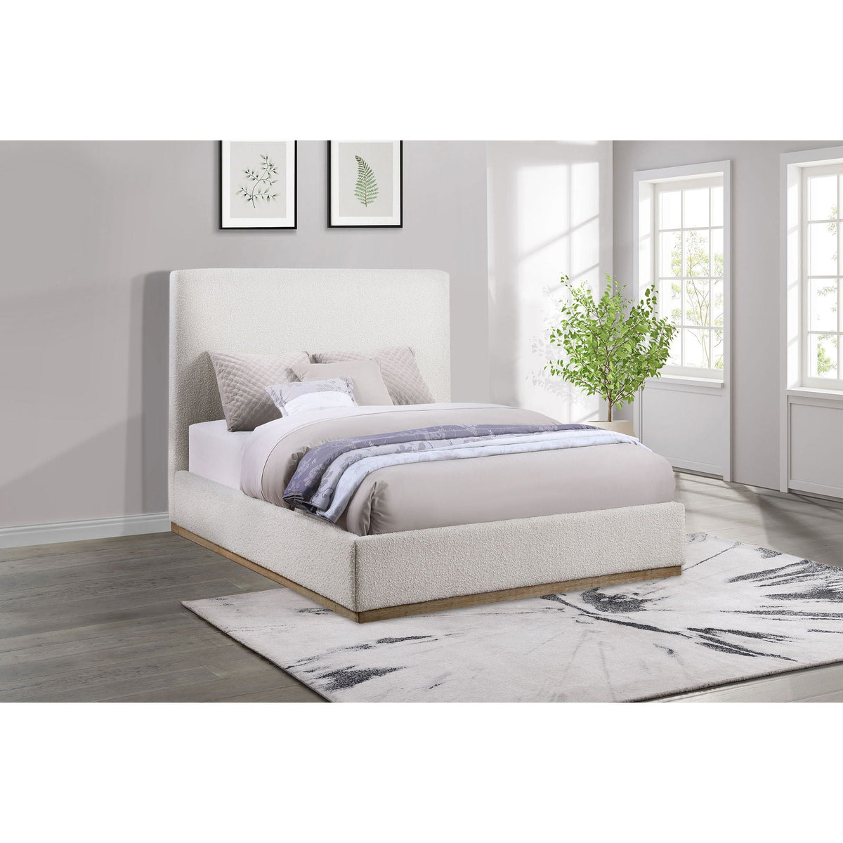 Othello platform bed cream upholstered bed with tall headboard in light gray bedroom and ferns on Tampa Home & Garden Store