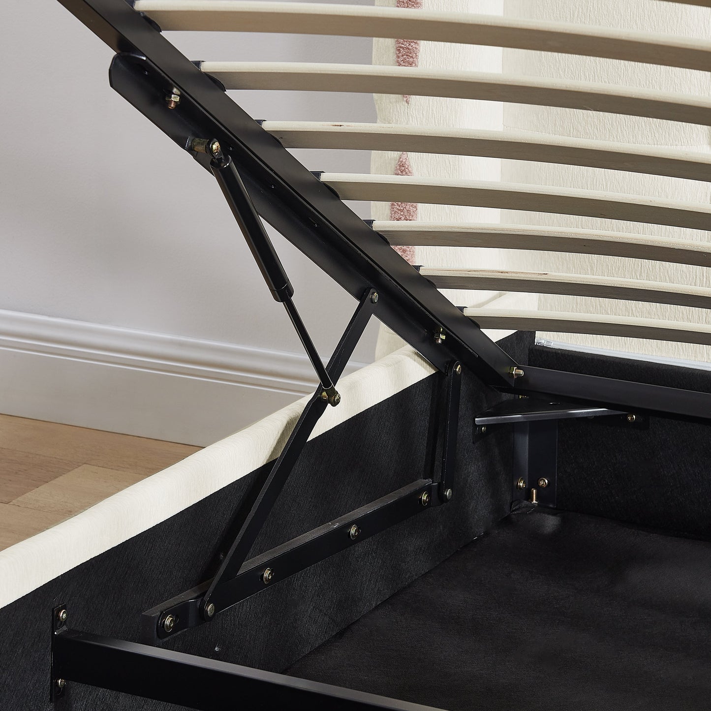 Queen size bed frame with black metal supports and beige slat platform bolts visible on Tampa Home & Garden Store