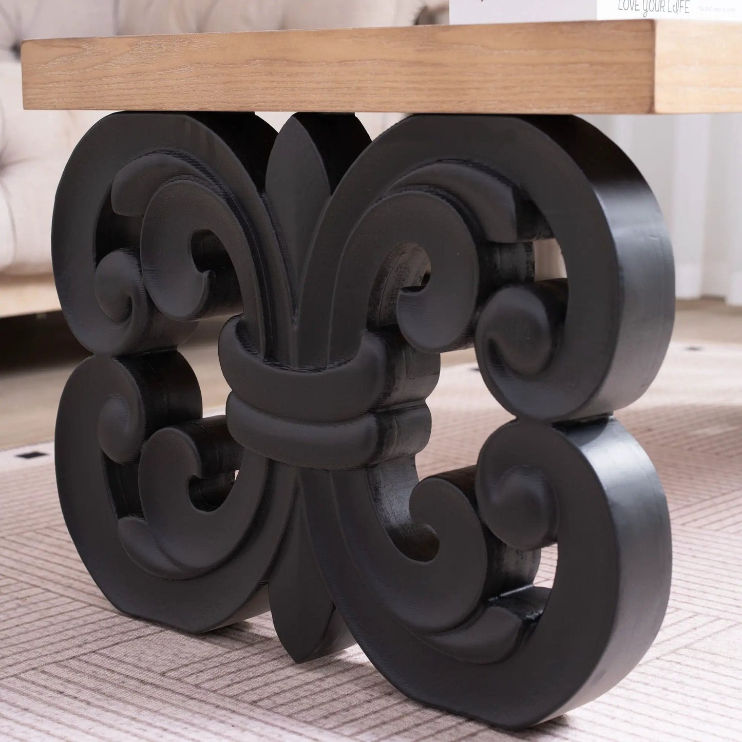 Ornate Scroll Base Coffee Table with natural wood top and black sculpted circular base on Tampa Home & Garden Store