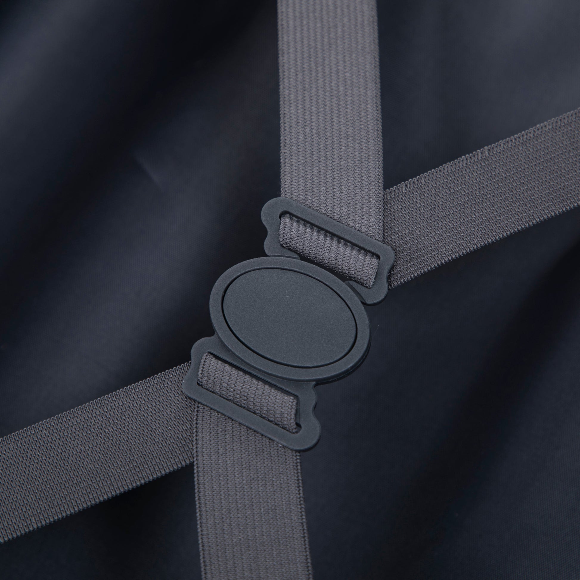 Luggage strap close-up gray nylon strap with plastic buckle on dark fabric on Tampa Home & Garden Store