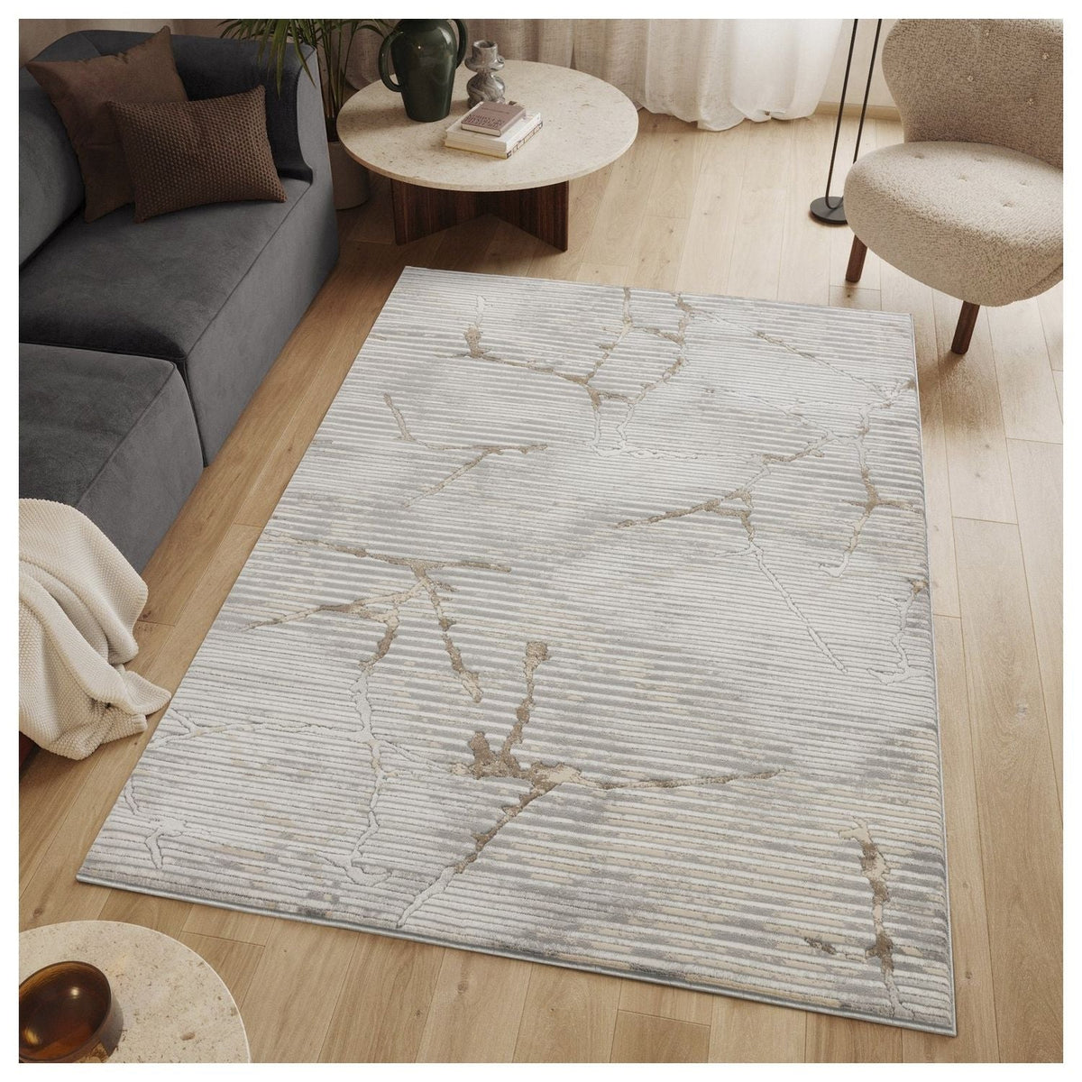 The Gray Geometric Area Rug with Soft Pile in a modern living room beside a gray sofa on Tampa Home & Garden Store