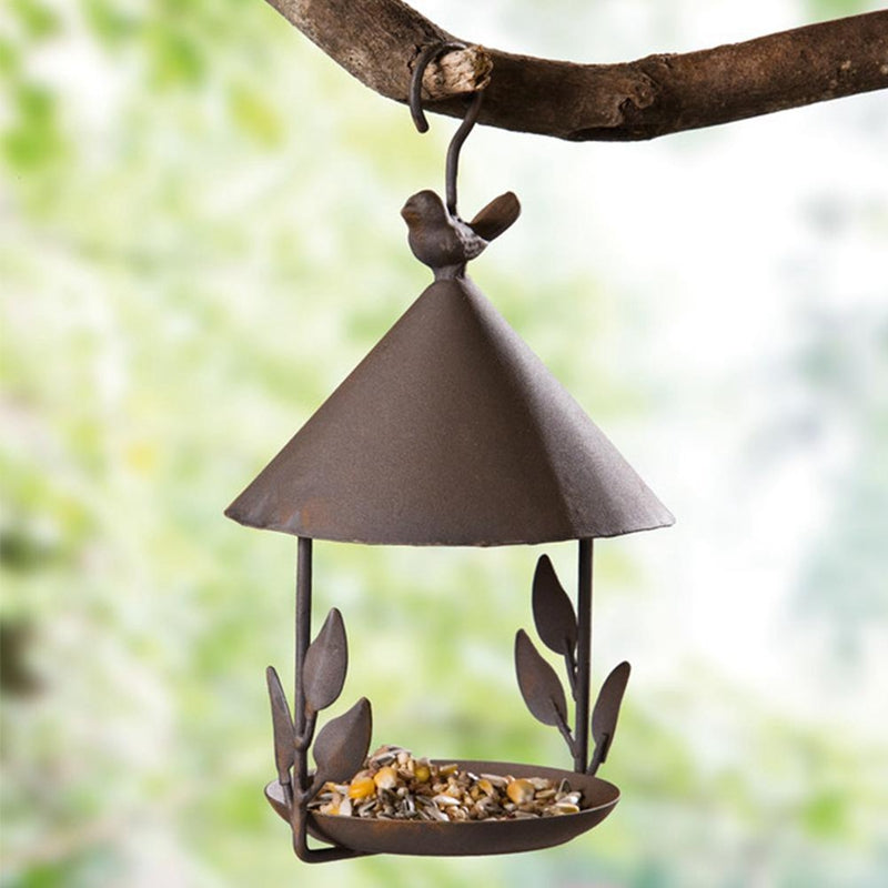 American made wrought iron bird feeder with cone roof and leaf accents hanging from a branch on Tampa Home & Garden Store