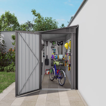 Lean-To storage shed gray metal with sloped roof, doors open revealing tools and bike on Tampa Home & Garden Store
