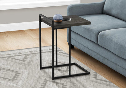 C-Shaped accent table with dark wood top and black metal frame beside blue sofa on Tampa Home & Garden Store