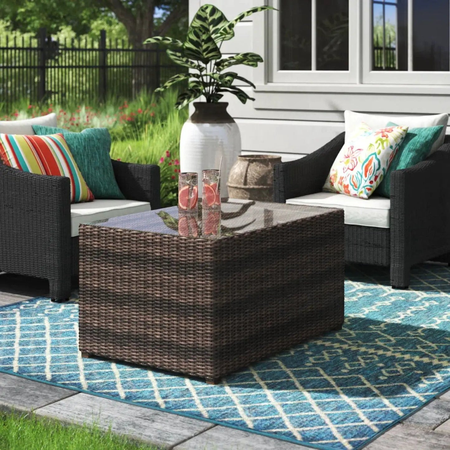 Coffee Table Stylish: dark brown woven rattan with glass top in an outdoor seating setup on Tampa Home & Garden Store